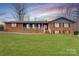 Charming brick home boasts a covered front porch and a spacious, well-manicured lawn at 822 Bethlehem Rd, Kings Mountain, NC 28086