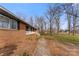 Charming brick home with a classic white porch railing and well-maintained walkway surrounded by mature trees at 822 Bethlehem Rd, Kings Mountain, NC 28086