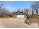 A two-car garage featuring a brick facade, a gray exterior and a concrete driveway under a clear blue sky at 822 Bethlehem Rd, Kings Mountain, NC 28086