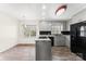 Traditional kitchen with gray cabinets, wood flooring, and an island with cooktop at 822 Bethlehem Rd, Kings Mountain, NC 28086