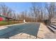 A large covered pool area with a diving board and black metal fencing, accompanied by a wood deck at 822 Bethlehem Rd, Kings Mountain, NC 28086