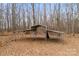 A pole barn stands amidst the trees, offering substantial covered storage space on the property at 822 Bethlehem Rd, Kings Mountain, NC 28086