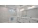 A modern bathroom features marble tile, dual vanities, and a glass-enclosed shower at 8233 Houser St, Cornelius, NC 28031