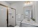 Clean bathroom with a glass shower, white subway tile, and warm bronze fixtures at 8233 Houser St, Cornelius, NC 28031
