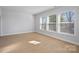 Spacious bedroom with large windows providing ample natural light and a neutral color palette at 8233 Houser St, Cornelius, NC 28031