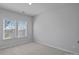 Bedroom with two large windows offering plenty of natural light and neutral walls and carpet at 8233 Houser St, Cornelius, NC 28031