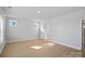 Spacious bonus room with large windows providing ample natural light and a neutral color palette at 8233 Houser St, Cornelius, NC 28031