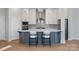 Stylish kitchen featuring white cabinetry, a gray backsplash, and a central island with seating at 8233 Houser St, Cornelius, NC 28031