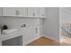Well-organized laundry room featuring ample cabinet space above the washer/dryer hookups and a countertop with room for folding at 8233 Houser St, Cornelius, NC 28031