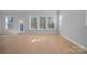 Bright and airy living room with hardwood floors and large windows allowing natural light at 8233 Houser St, Cornelius, NC 28031