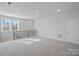 Spacious loft featuring large windows, a door, and sleek railing at 8233 Houser St, Cornelius, NC 28031