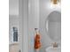 Stylish powder room features contemporary fixtures, a round mirror, and neutral finishes at 8233 Houser St, Cornelius, NC 28031