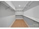 Open walk-in closet offering ample storage with shelving on both sides of the room at 8233 Houser St, Cornelius, NC 28031
