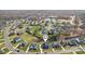 An aerial view shows the property in a serene neighborhood with lush trees, a lake, and community amenities at 8638 Raven Top Dr, Mint Hill, NC 28227