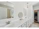 Bathroom featuring double sinks with white countertops, decorative mirror, stylish vanity lighting, and a glass door shower at 8638 Raven Top Dr, Mint Hill, NC 28227