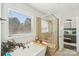 Bright bathroom featuring soaking tub, tiled shower with a glass door and view to the main bedroom at 8638 Raven Top Dr, Mint Hill, NC 28227