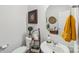 Charming powder room featuring a stylish sink, decorative mirror, and modern fixtures at 8638 Raven Top Dr, Mint Hill, NC 28227