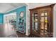 Bright entryway with wood floors, an open dining and kitchen, a display cabinet, and view to living area at 8638 Raven Top Dr, Mint Hill, NC 28227