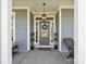 Close-up of the front door with decorative wreath and sidelights at 8638 Raven Top Dr, Mint Hill, NC 28227