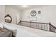 Hallway with wooden floors and staircase, accentuated with decorative wall hangings at 8638 Raven Top Dr, Mint Hill, NC 28227