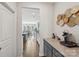 Hallway leading to the kitchen with a coffee bar station with granite countertops and decorative wall art at 8638 Raven Top Dr, Mint Hill, NC 28227