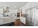 Bright kitchen features white cabinets, stainless steel appliances, granite countertops, and wood floors at 8638 Raven Top Dr, Mint Hill, NC 28227
