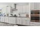 The well-equipped kitchen features stainless steel appliances, white cabinetry, and granite counters at 8638 Raven Top Dr, Mint Hill, NC 28227