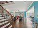 Spacious living room with stairs, fireplace, built-in shelving, and a view to dining and kitchen areas at 8638 Raven Top Dr, Mint Hill, NC 28227