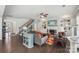 Inviting living room with hardwood floors, fireplace, ceiling fan, and staircase view to front door at 8638 Raven Top Dr, Mint Hill, NC 28227