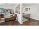 Cozy loft space featuring a chaise lounge, shelving, and a view of the upstairs hallway at 8638 Raven Top Dr, Mint Hill, NC 28227