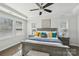 Bright main bedroom featuring tray ceiling, large windows, and tastefully decorated with stylish furniture and artwork at 8638 Raven Top Dr, Mint Hill, NC 28227