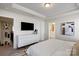 Comfortable bedroom featuring tray ceilings, modern furnishings, and an ensuite bathroom at 9042 Northfield Crossing Dr, Charlotte, NC 28269