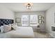 Bright bedroom featuring neutral decor, plush carpeting, and a tufted headboard, offering a serene retreat at 9042 Northfield Crossing Dr, Charlotte, NC 28269