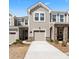 Charming townhome featuring a stone facade, attached garage, and well-maintained landscaping at 9042 Northfield Crossing Dr, Charlotte, NC 28269