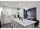 Bright kitchen with an island featuring barstool seating and a view into the dining area at 9042 Northfield Crossing Dr, Charlotte, NC 28269