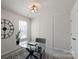 Well-lit office featuring a modern glass desk, black and white rug, and a large window at 9042 Northfield Crossing Dr, Charlotte, NC 28269