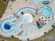 Overhead aerial captures lazy river and water slides in community pool area with plenty of lounge chairs and umbrellas at 924 Stebbins Dr, Fort Mill, SC 29715