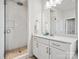 Updated bathroom featuring a glass-enclosed shower with white tile and pebble floor, plus white vanity at 924 Stebbins Dr, Fort Mill, SC 29715