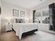 Neutral bedroom featuring a large window, gray accents, and carpet flooring at 924 Stebbins Dr, Fort Mill, SC 29715