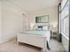 Cozy bedroom with white furniture, soft blue and white bedding, and a bright window at 924 Stebbins Dr, Fort Mill, SC 29715
