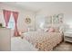 Charming bedroom featuring pink curtains, decorative wall art, and a patterned comforter at 924 Stebbins Dr, Fort Mill, SC 29715