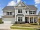 Charming two-story home with gray siding, black shutters, and a well-manicured front yard at 924 Stebbins Dr, Fort Mill, SC 29715