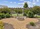 Cozy fire pit with seating and pergola is nestled among mature trees, creating a relaxing community gathering spot at 924 Stebbins Dr, Fort Mill, SC 29715