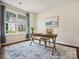 Bright home office featuring a wooden desk, comfortable seating, and a large window at 924 Stebbins Dr, Fort Mill, SC 29715