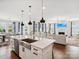 Open kitchen view showcasing stainless steel appliances, center island with seating, and view to the living room at 924 Stebbins Dr, Fort Mill, SC 29715
