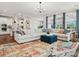 Bright, open-concept living room with large sectional sofa, modern chandelier, and direct access to the kitchen area at 924 Stebbins Dr, Fort Mill, SC 29715