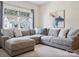 Comfortable living room features a large gray sectional sofa, neutral carpet, and a bright window at 924 Stebbins Dr, Fort Mill, SC 29715