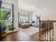 Bright living room featuring a comfortable gray sectional sofa, large window, and hardwood floors at 924 Stebbins Dr, Fort Mill, SC 29715