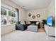 Cozy living room with a large window, a comfortable sectional sofa, and a stylish ottoman at 924 Stebbins Dr, Fort Mill, SC 29715