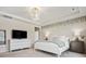 Calm primary bedroom with a large bed, leafy wall decor, and soft lighting at 924 Stebbins Dr, Fort Mill, SC 29715